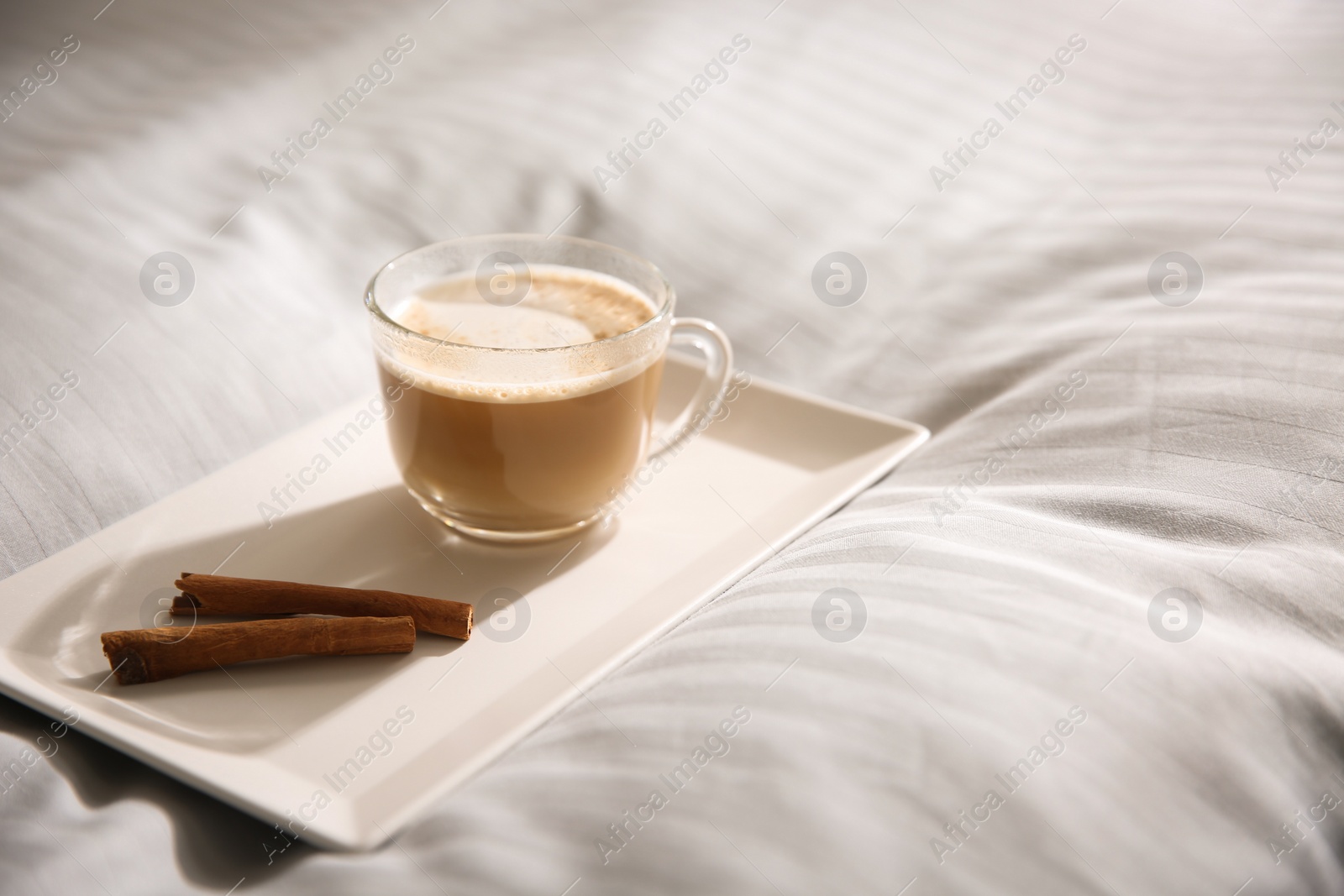 Photo of Tray with morning coffee on soft blanket. Space for text