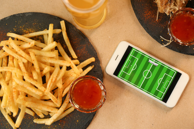 Photo of Flat lay composition with smartphone and french fries on table