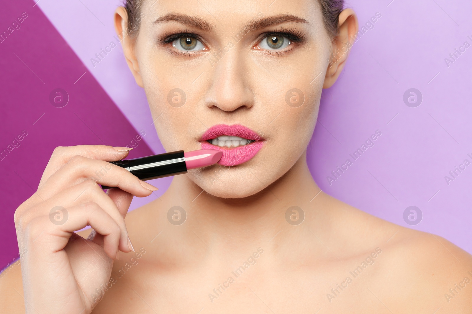 Photo of Young woman with beautiful lipstick on color background