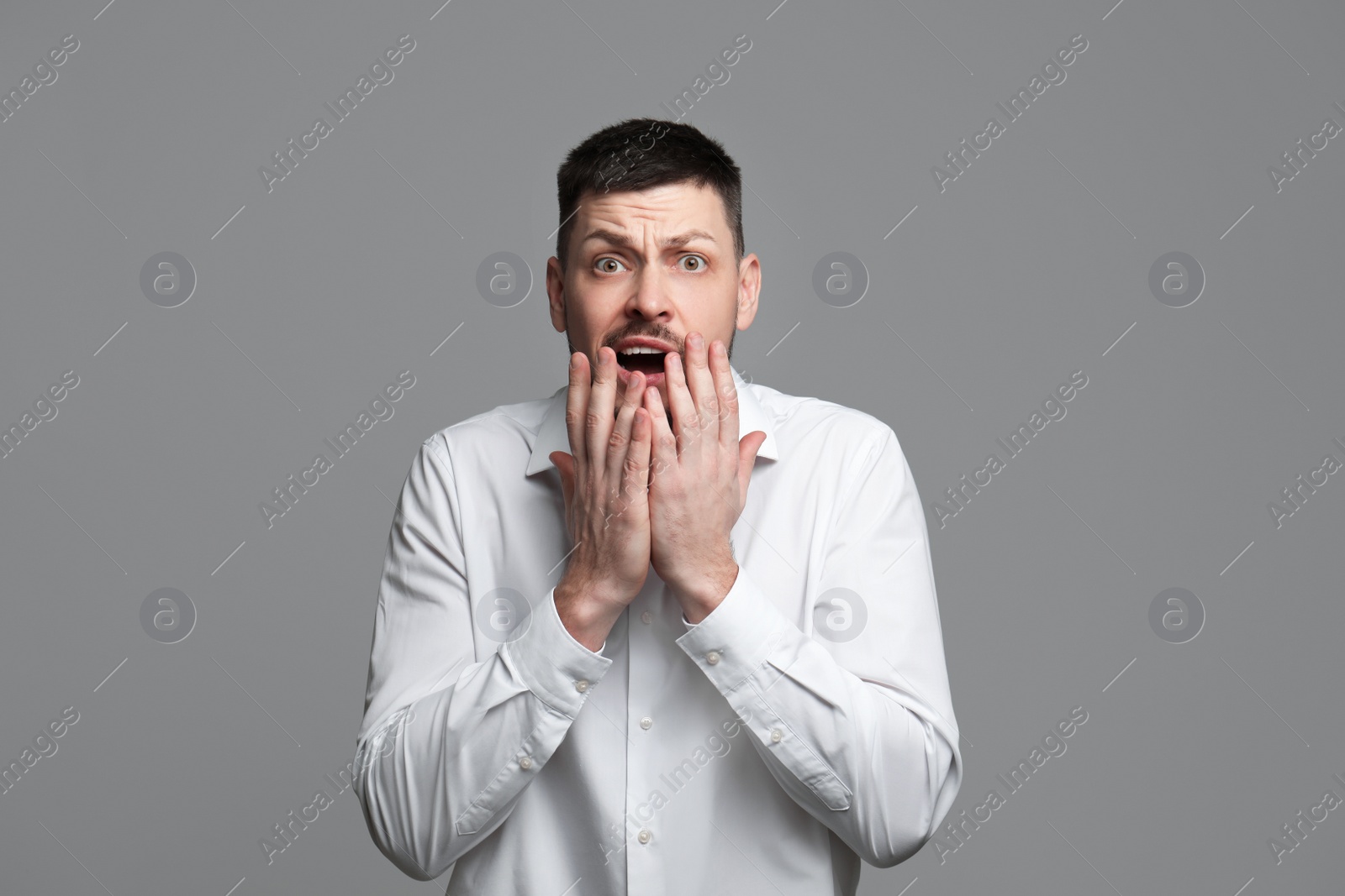 Photo of Portrait of man feeling fear on grey background