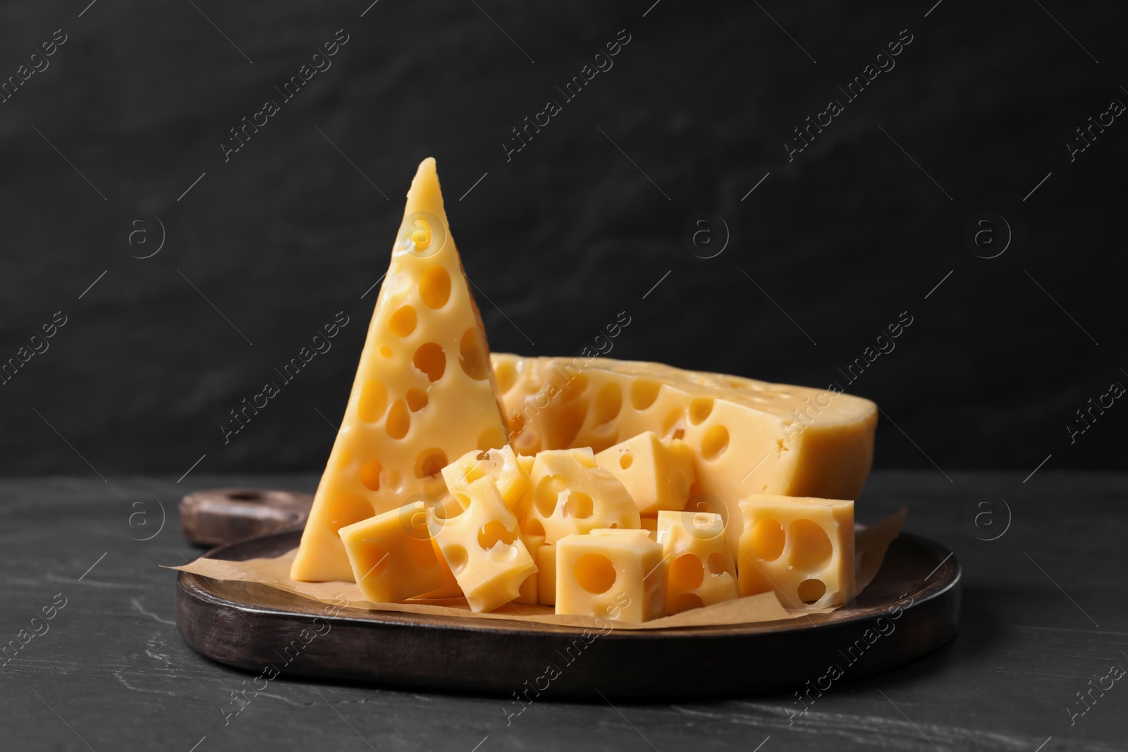 Photo of Tasty fresh cheese on dark grey table