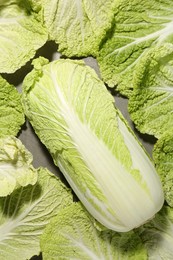 Fresh ripe Chinese cabbage and green leaves on table, top view