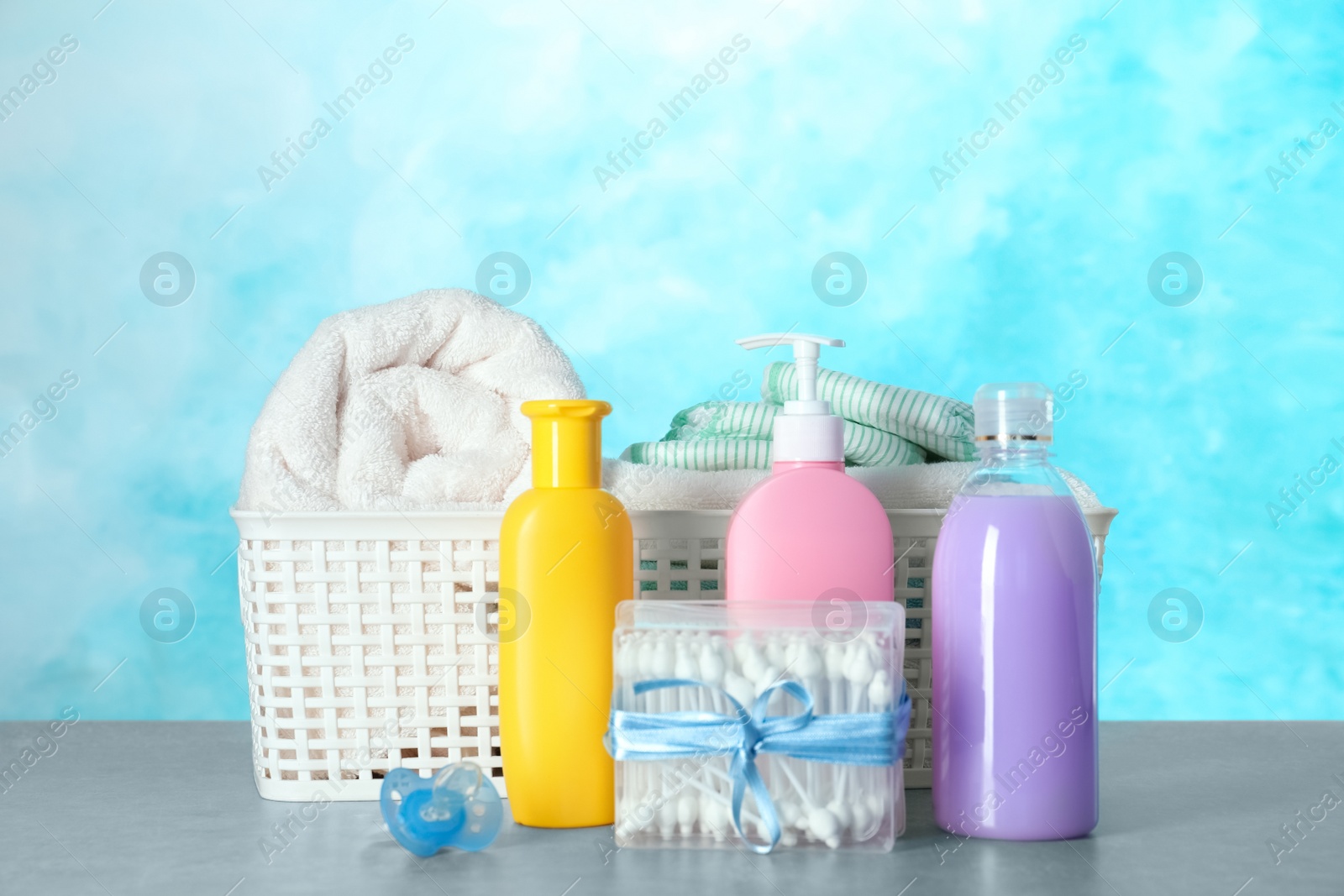 Photo of Set of different baby accessories on table against color background