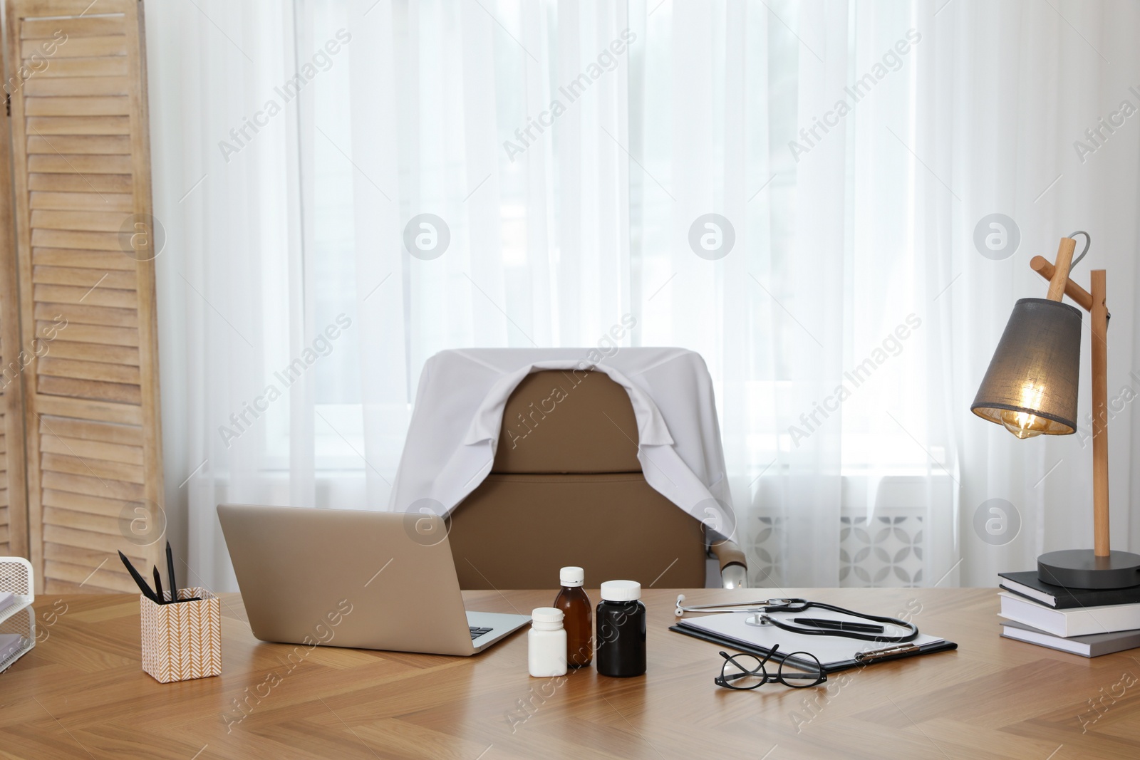 Photo of Modern doctor's workplace in stylish office. Interior design