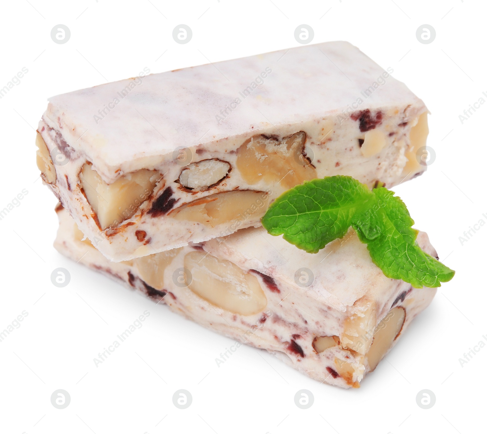 Photo of Pieces of delicious nougat and mint on white background