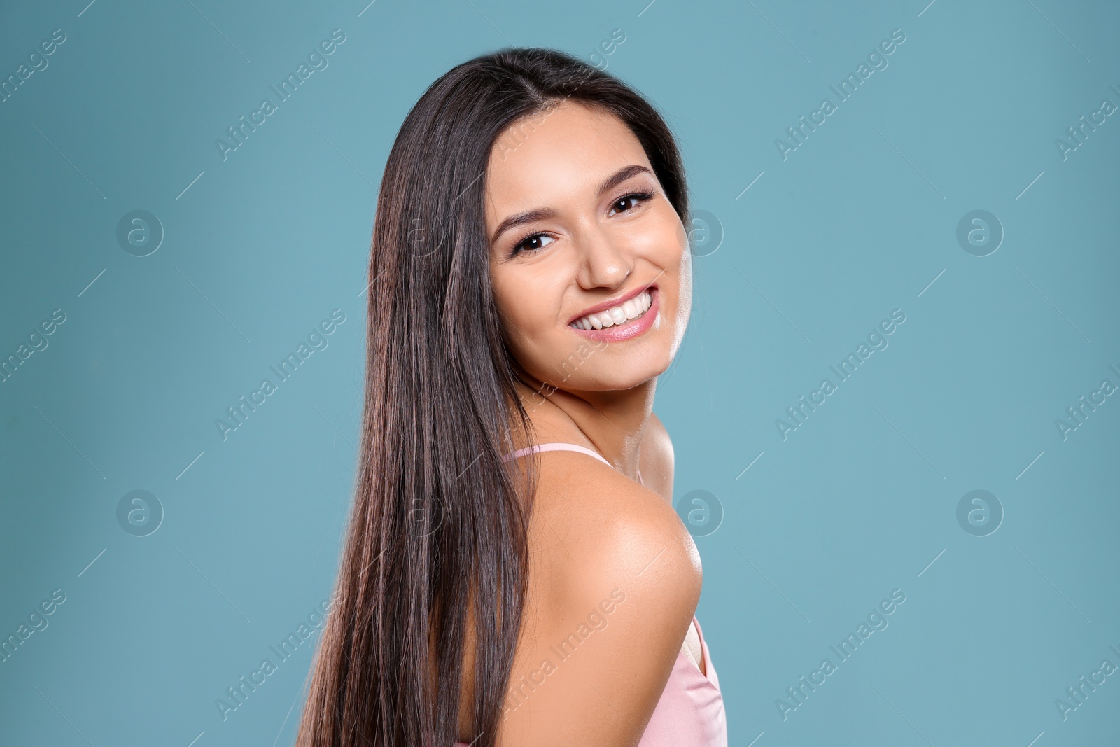 Photo of Portrait of beautiful model with gorgeous straight hair on color background