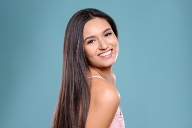 Photo of Portrait of beautiful model with gorgeous straight hair on color background