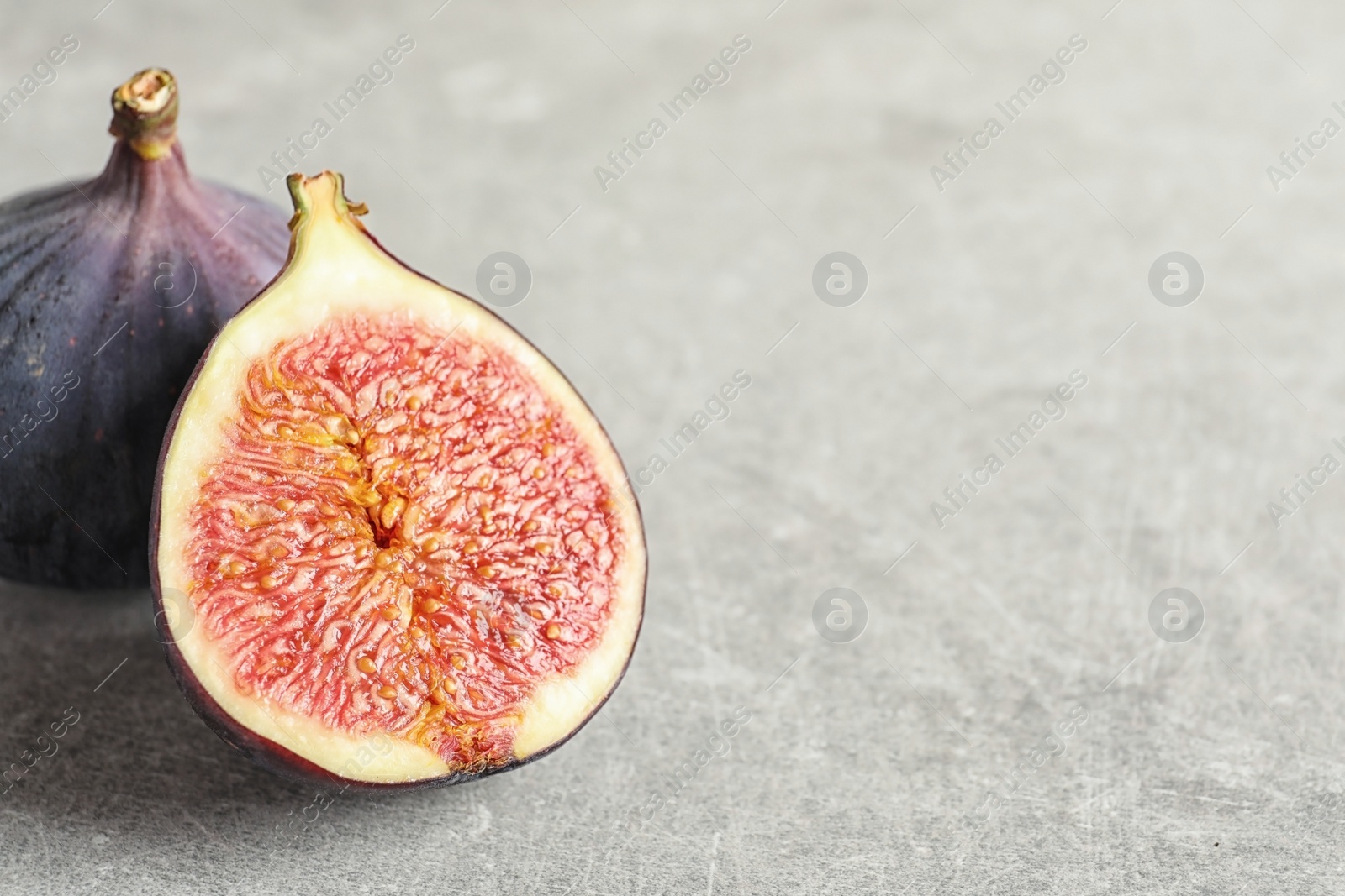 Photo of Fresh ripe figs and space for text on gray background