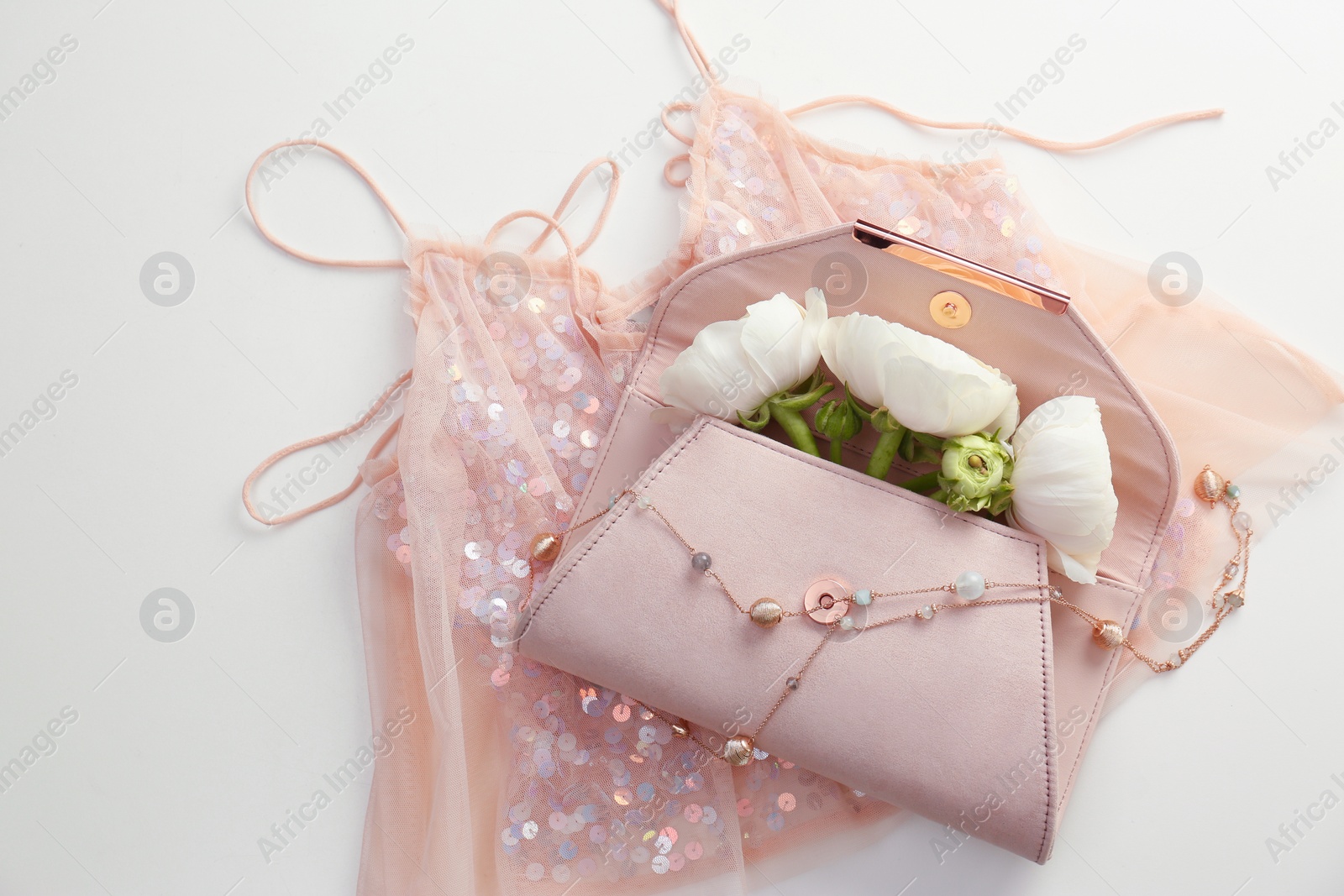 Photo of Flat lay composition with stylish clutch bag and spring flowers on light background