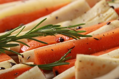 Photo of Slices of parsnip and carrot with rosemary, closeup