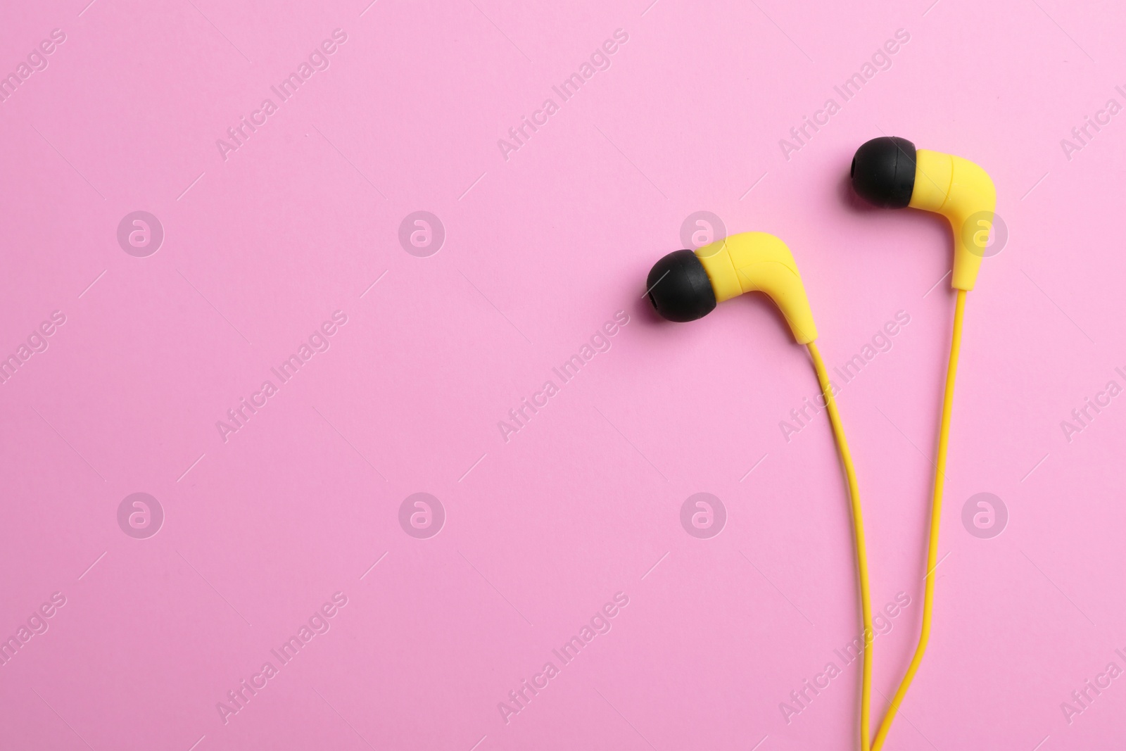 Photo of Stylish headphones on color background, top view. Space for text