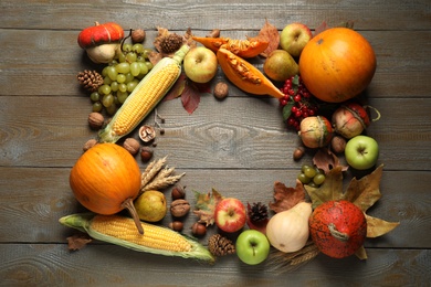 Frame made of autumn vegetables and fruits on wooden background, top view with space for text. Happy Thanksgiving day