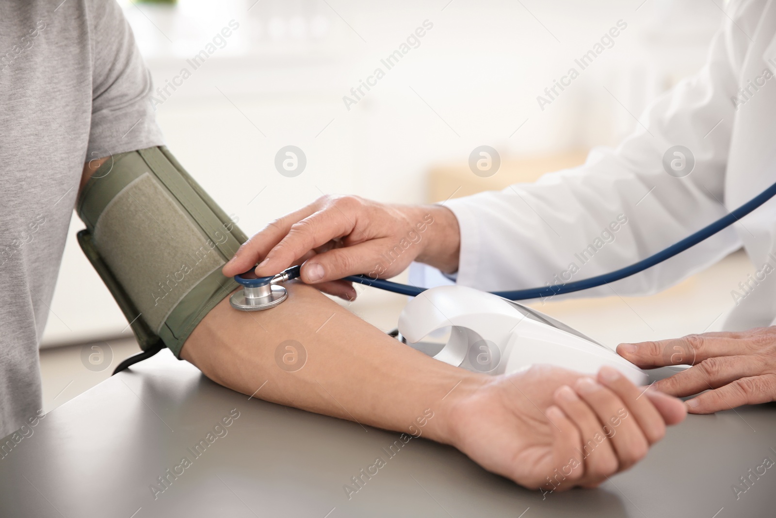 Photo of Doctor measuring patient's blood pressure in hospital