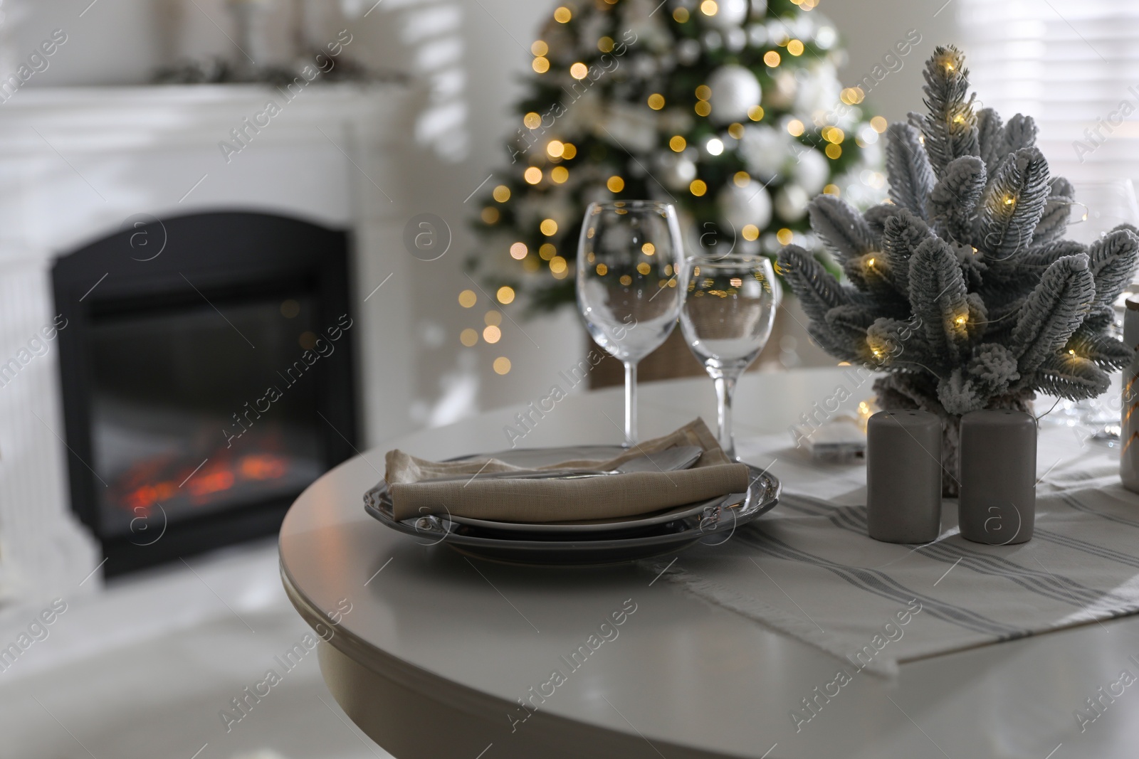 Photo of Festive table setting and beautiful Christmas decor indoors. Interior design