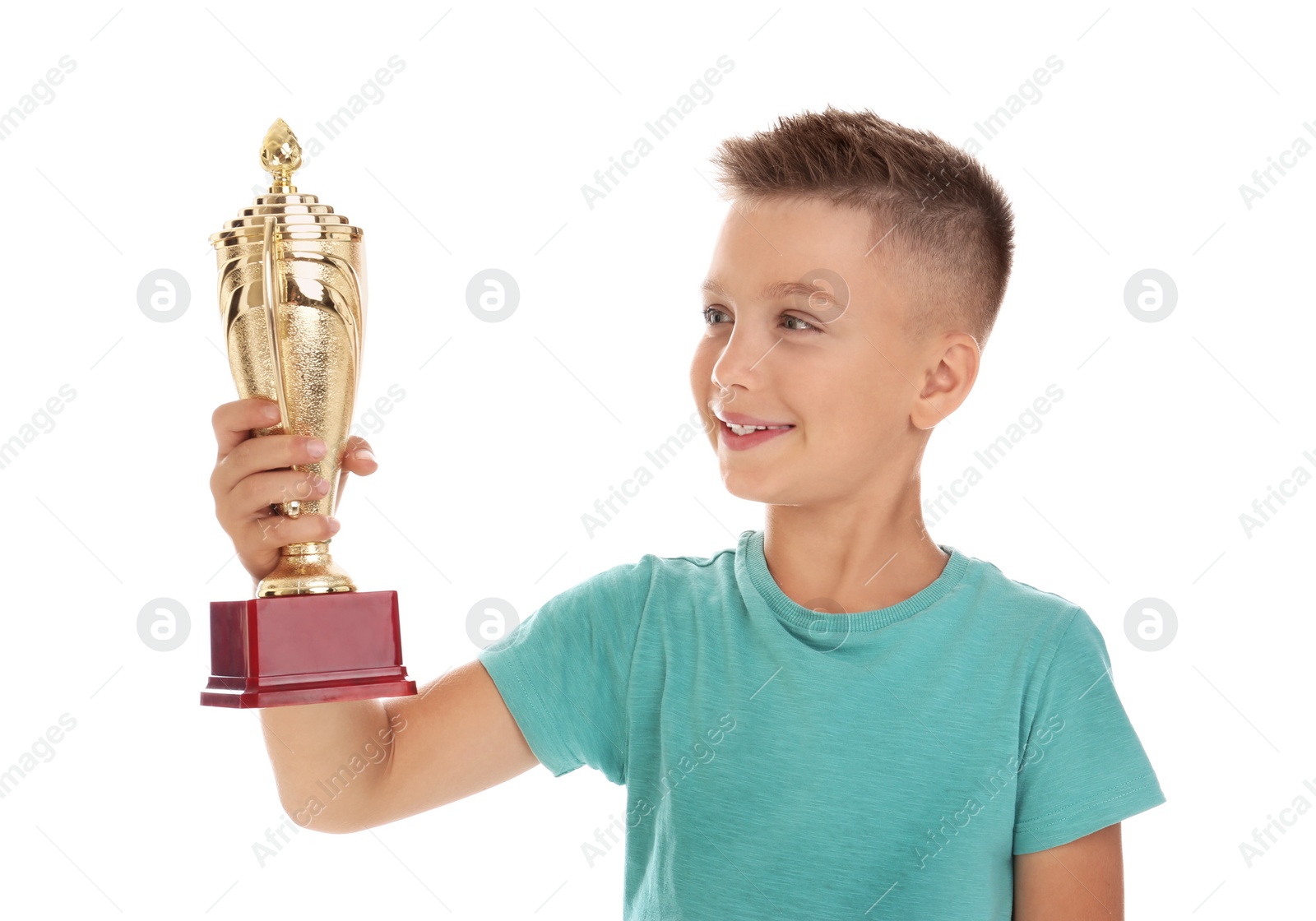 Photo of Happy boy with golden winning cup isolated on white