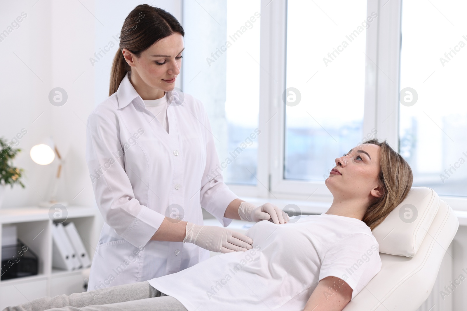 Photo of Mammologist checking young woman's breast in hospital