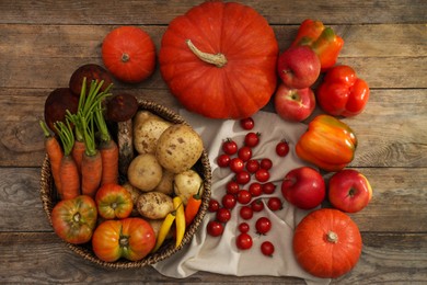 Different fresh ripe vegetables and fruits on wooden table, flat lay