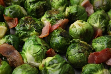Photo of Delicious roasted Brussels sprouts and bacon as background, closeup