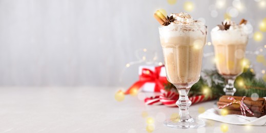 Image of Delicious Christmas cocktail with liqueur on white table, space for text. Banner design