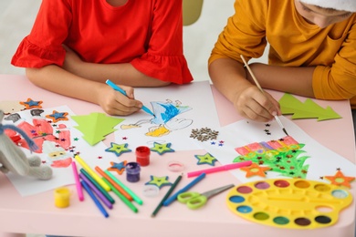 Little children drawing at table indoors, closeup. Christmas season