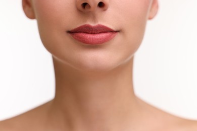 Woman with beautiful lips on white background, closeup