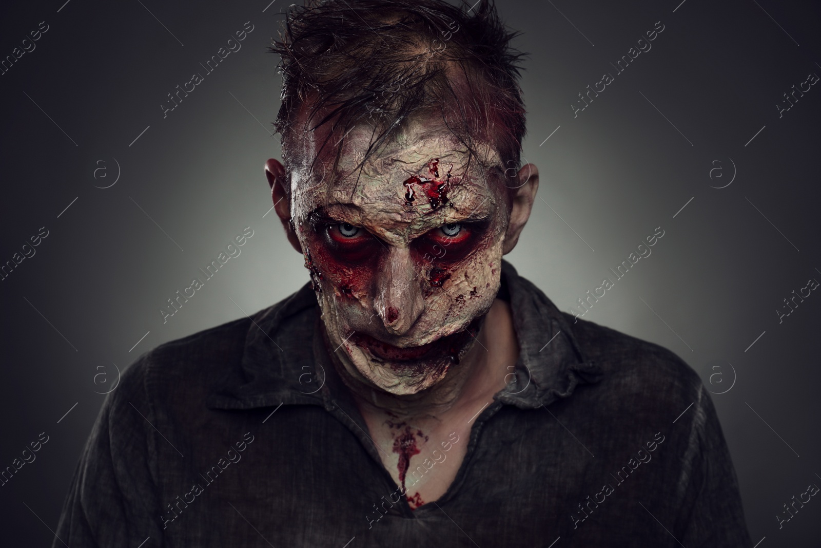 Photo of Scary zombie on dark background. Halloween monster