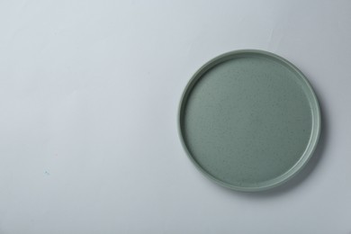 Photo of Clean plate on light grey background, top view. Space for text