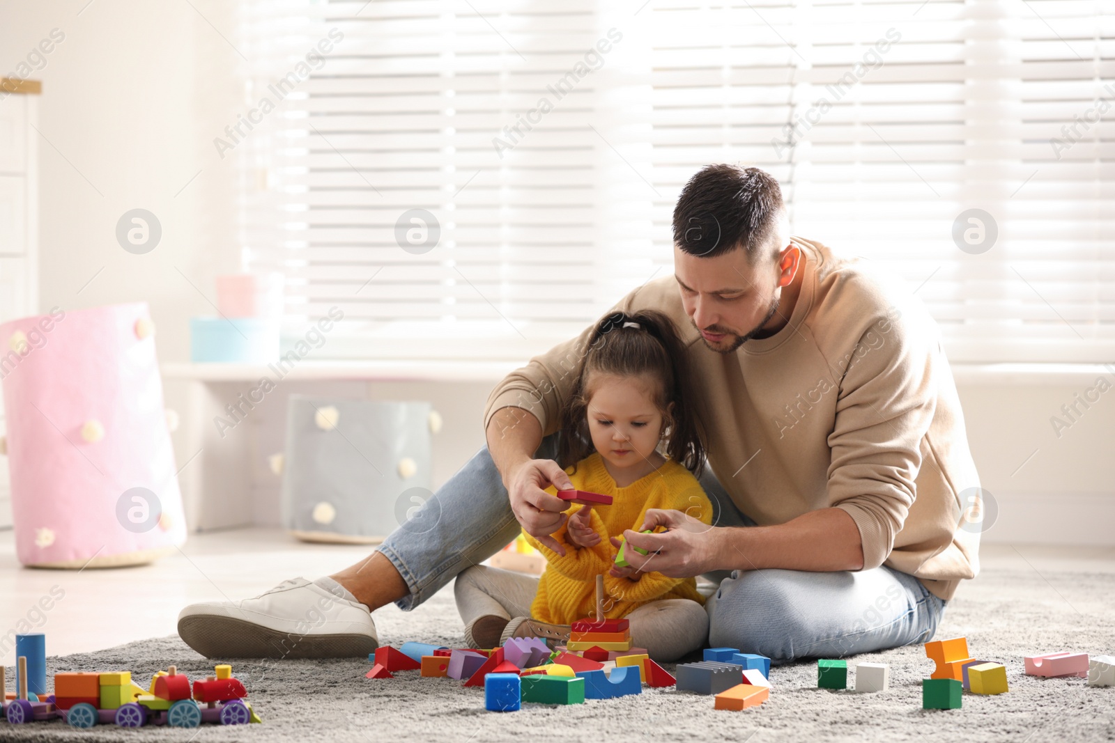 Photo of Father playing with his child at home