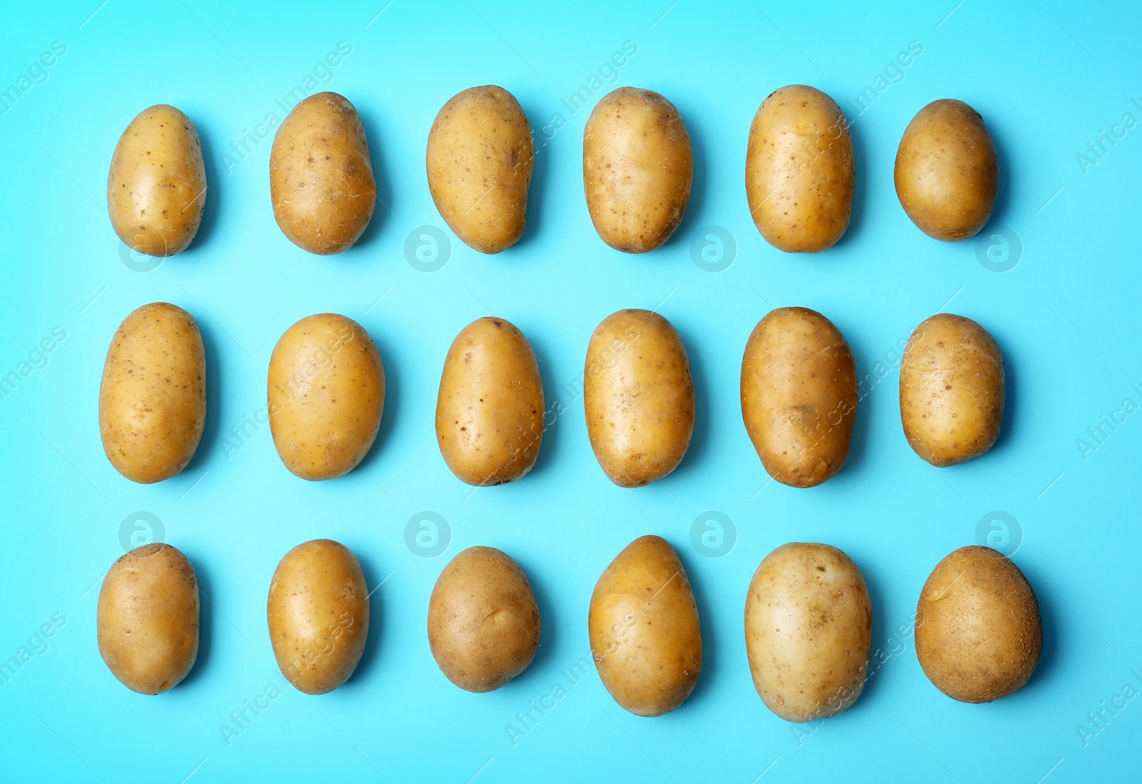 Photo of Flat lay composition with fresh ripe organic potatoes on color background