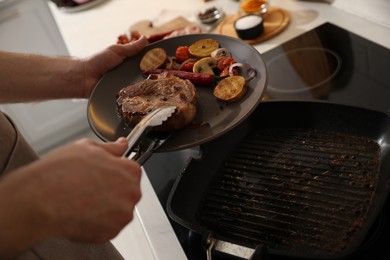 Man with tasty meat and vegetables cooked on frying pan, closeup
