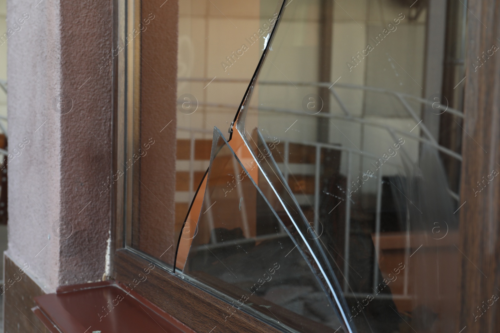 Photo of Broken window with sharp smithereens outdoors. Requiring repair