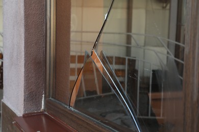 Photo of Broken window with sharp smithereens outdoors. Requiring repair