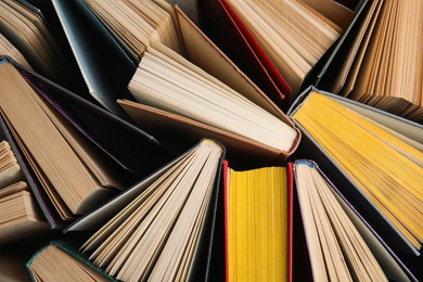 Photo of Stack of hardcover books as background, top view