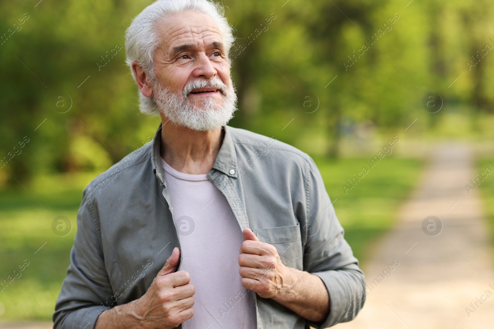 Photo of Portrait of happy grandpa in spring park