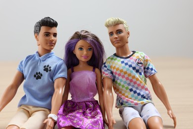 Leiden, Netherlands - September 20, 2023: Stylish Barbie and Ken dolls on table against light gray background