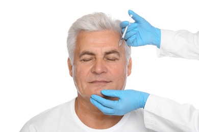 Photo of Senior man getting facial injection on white background. Cosmetic surgery concept