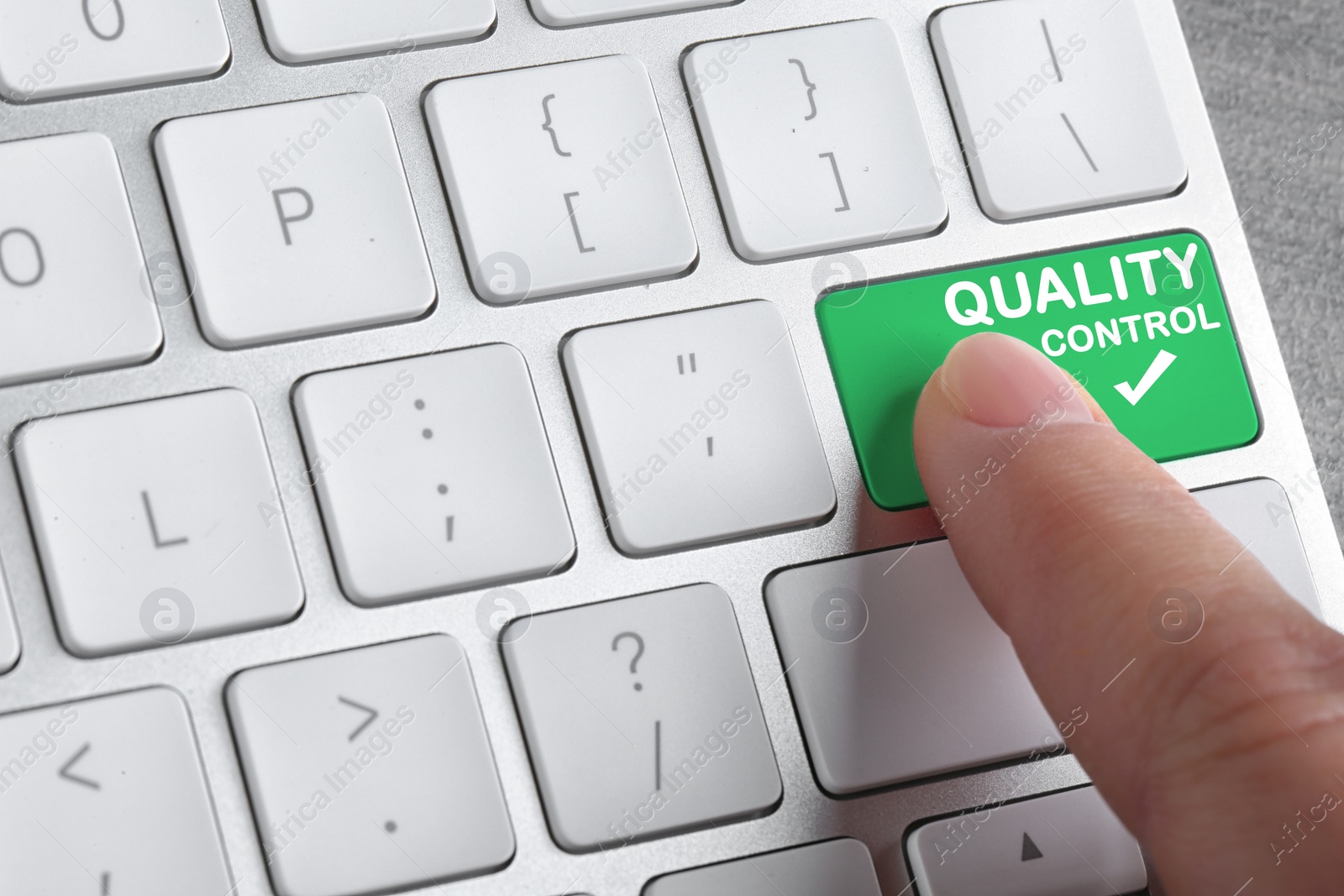 Image of Woman pressing quality control button on computer keyboard, closeup