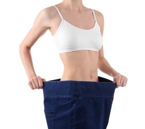 Photo of Young slim woman wearing oversized jeans on white background, closeup