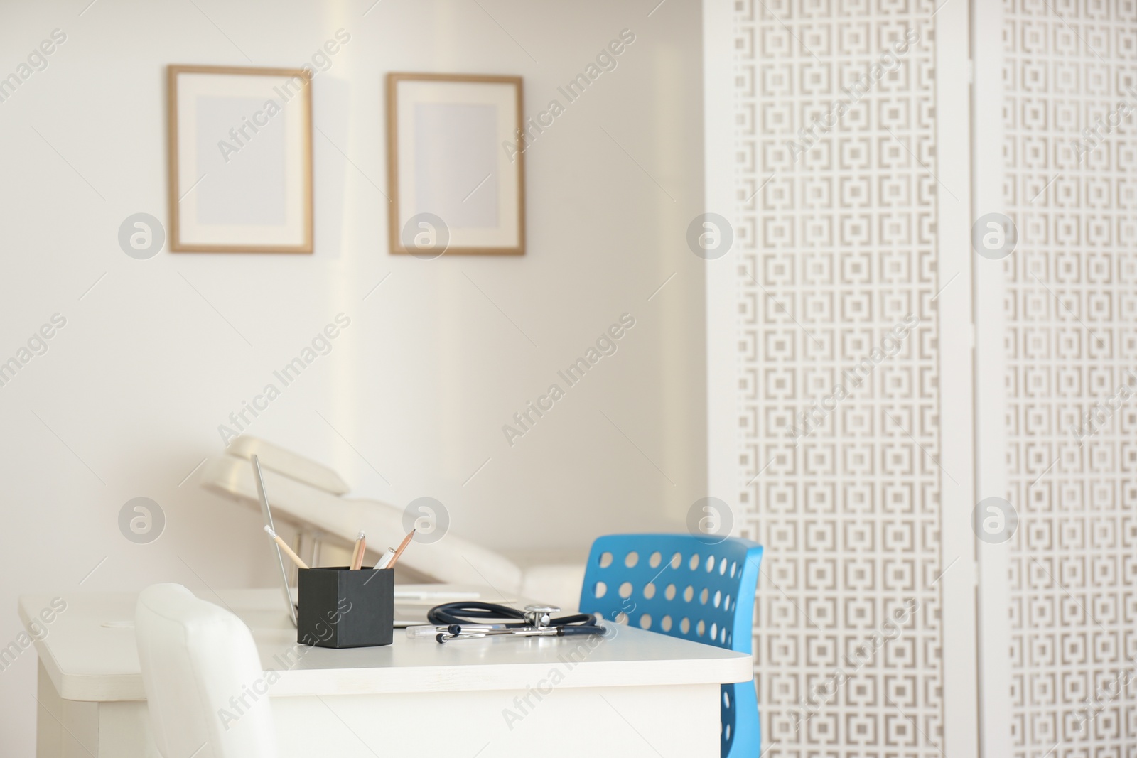 Photo of Doctor's workplace with modern laptop in medical office