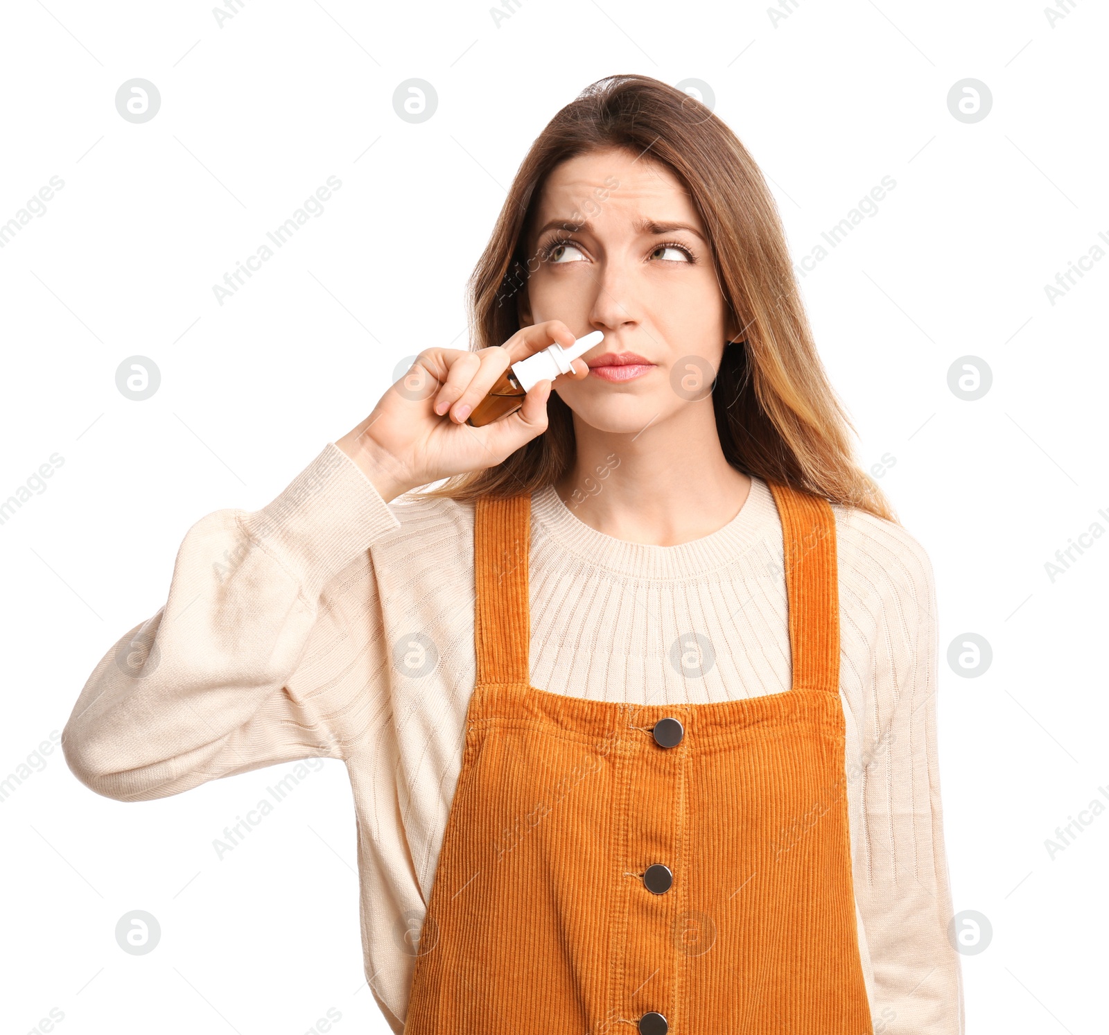 Photo of Sick young woman using nasal spray on white background