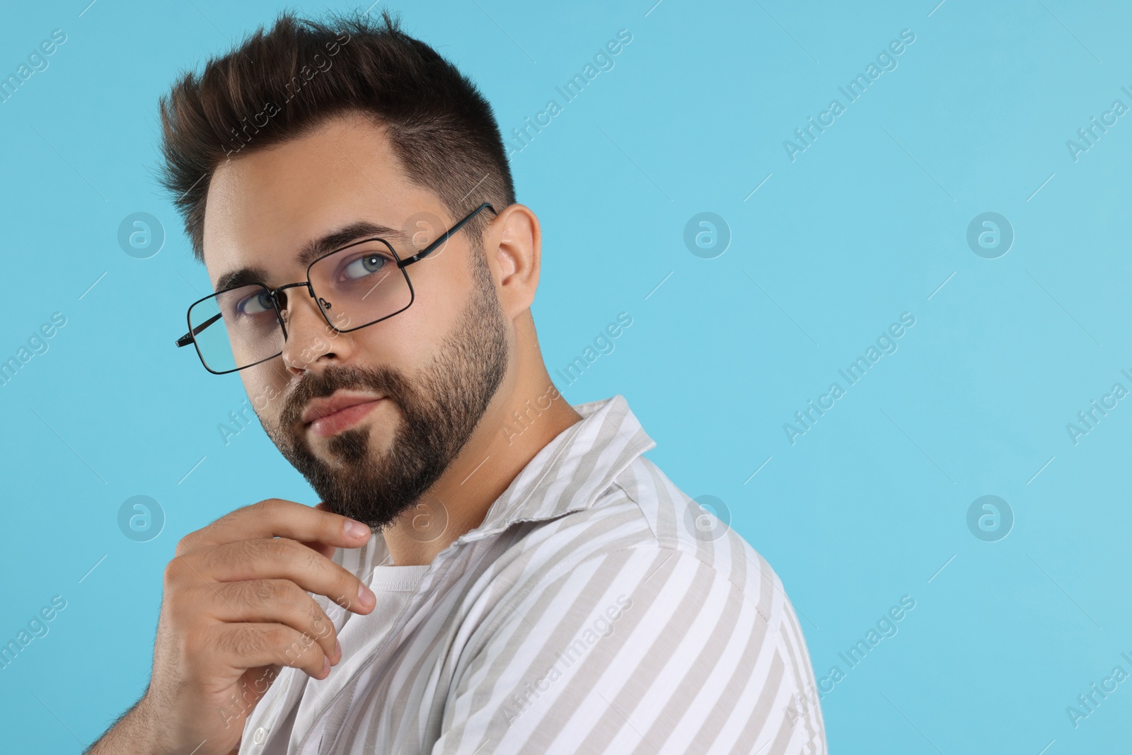 Photo of Handsome man wearing glasses on turquoise background, space for text