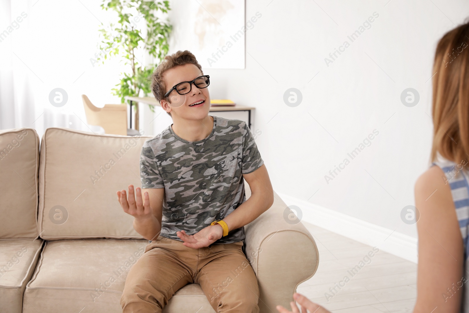 Photo of Mother talking with her teenager son at home