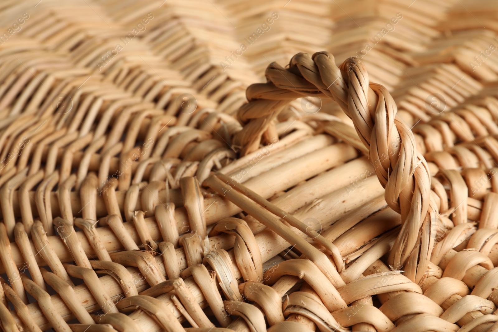 Photo of Lid of handmade wicker basket as background, closeup