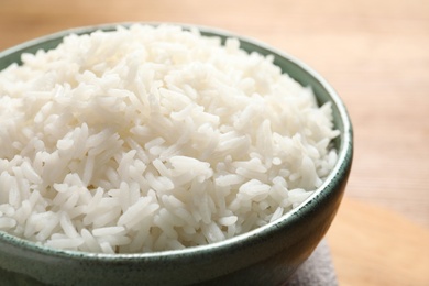 Bowl of tasty cooked white rice on table, closeup