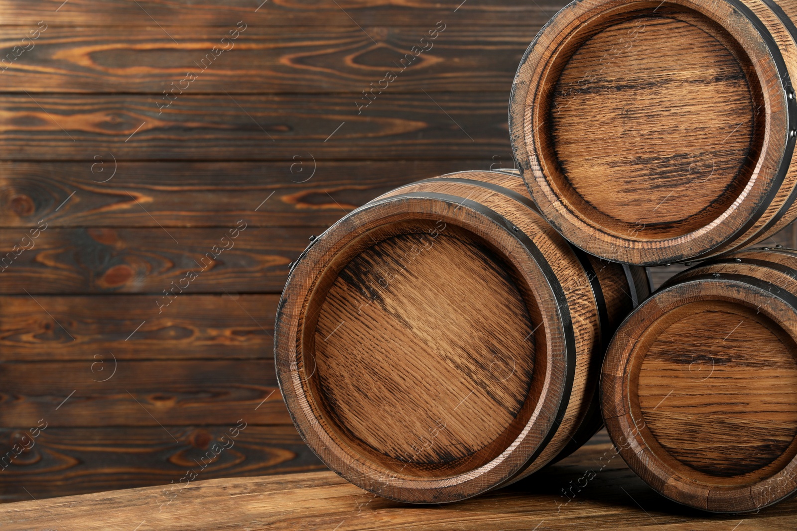 Photo of Wooden barrels on table, space for text