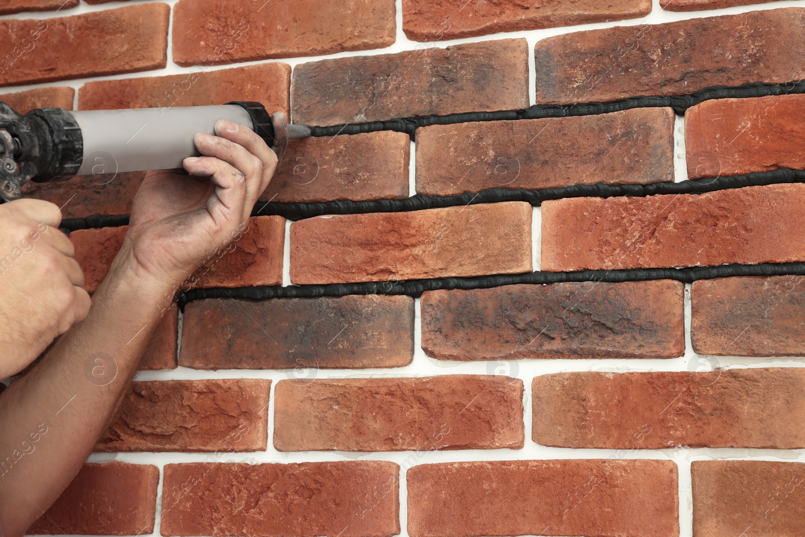 Photo of Professional builder using tiling fugue for grouting, closeup