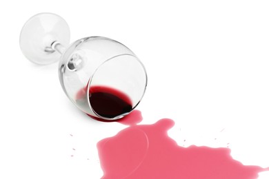 Photo of Overturned glass and spilled wine on white background