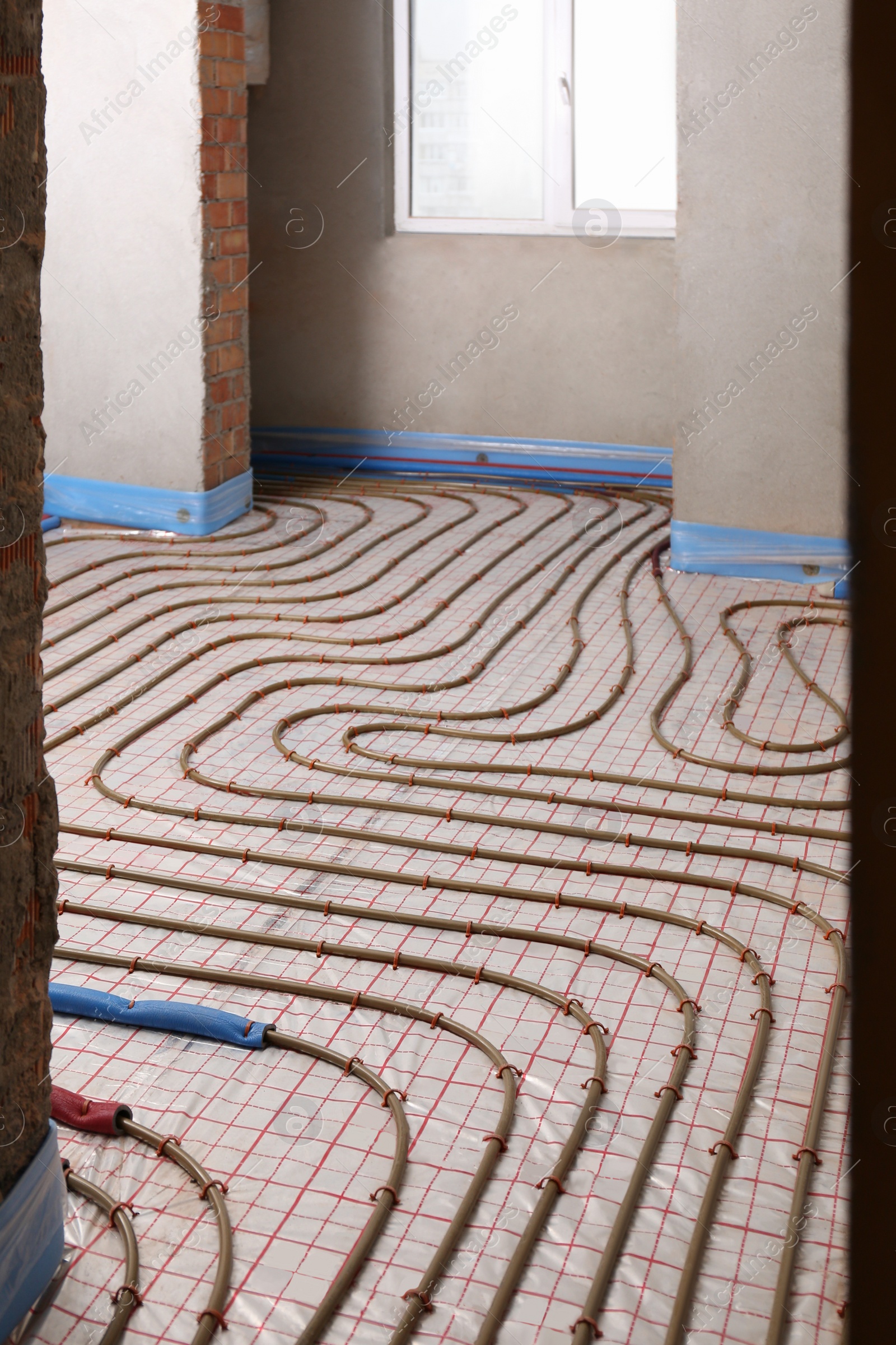 Photo of Installation of underfloor heating system in building