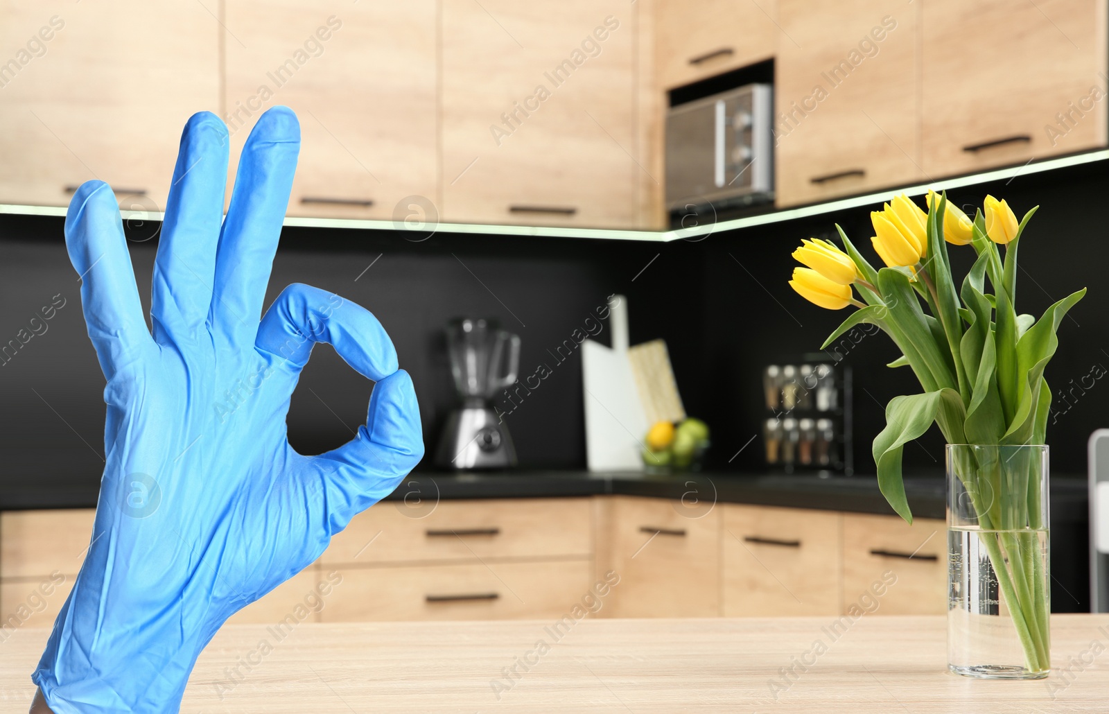 Image of Keep your home virus-free. Woman showing Ok in clean kitchen