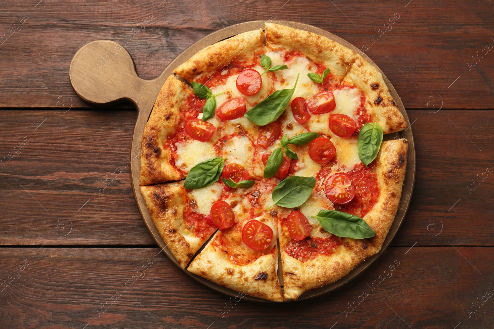 Photo of Delicious Margherita pizza on wooden table, top view